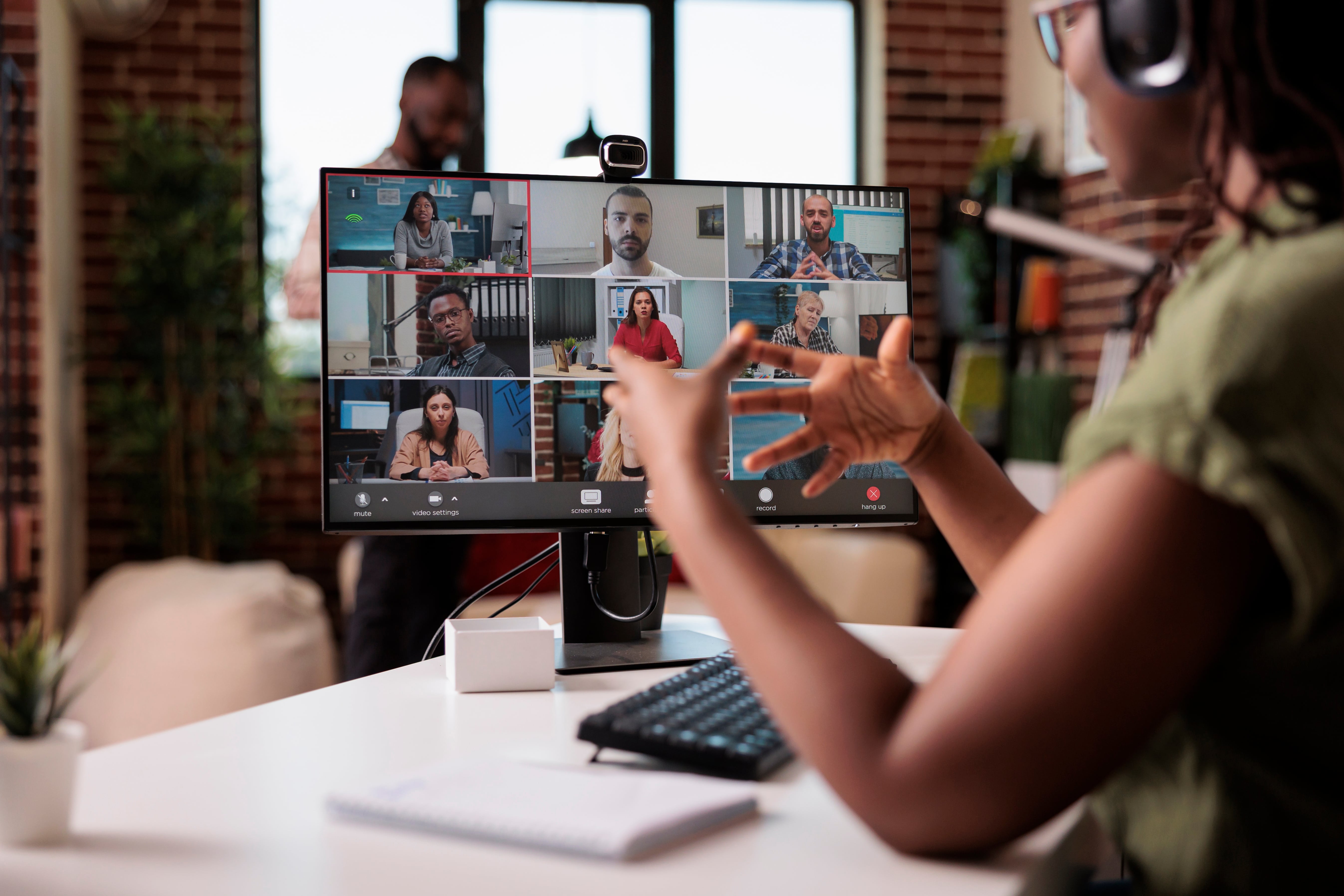 woman on video call with many people